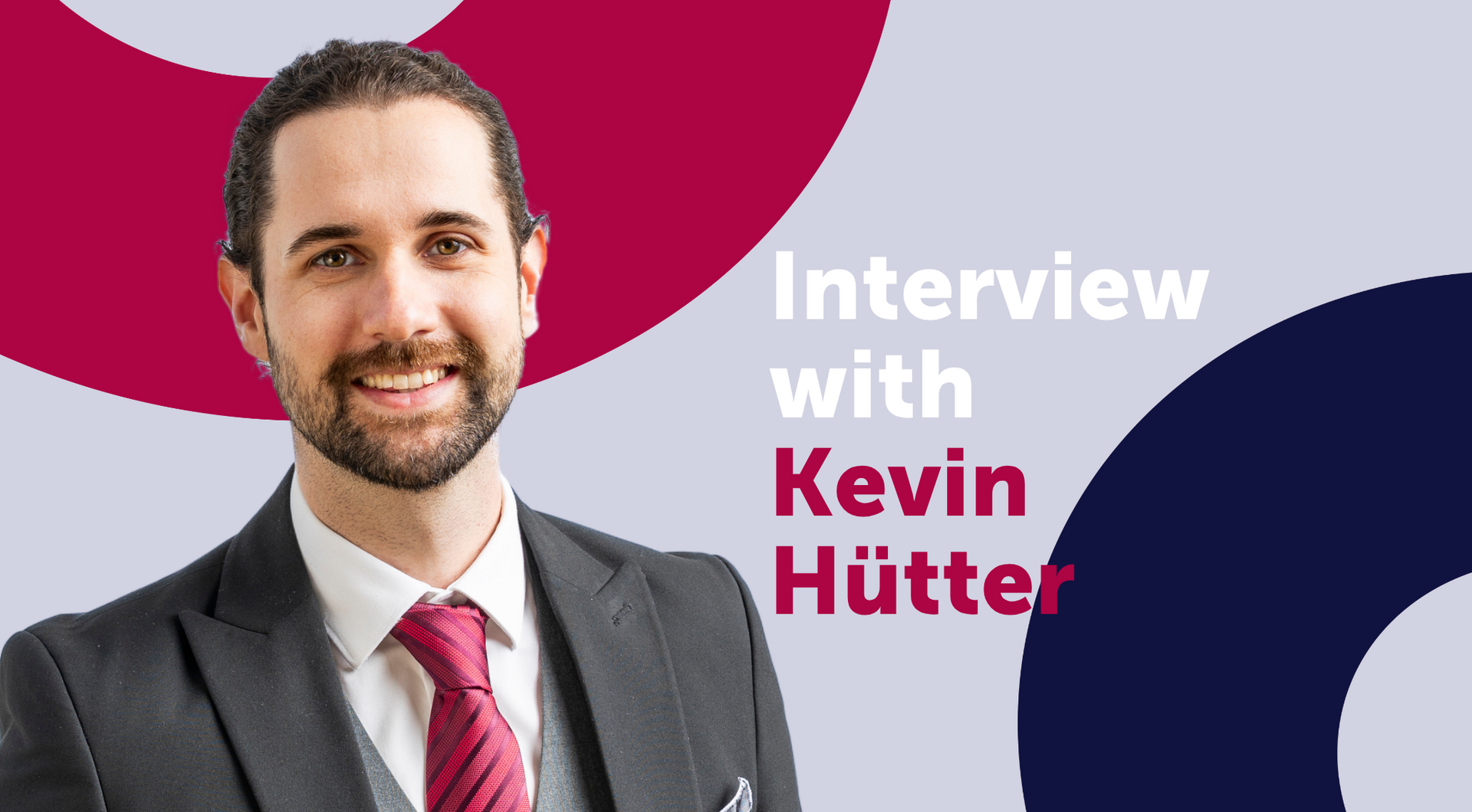 Man in a suit smiles, interview with Kevin Hütter